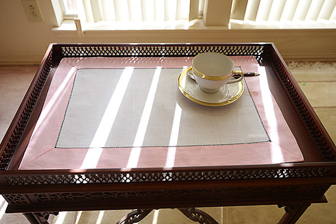 Place Mat. Pink colored trimming.